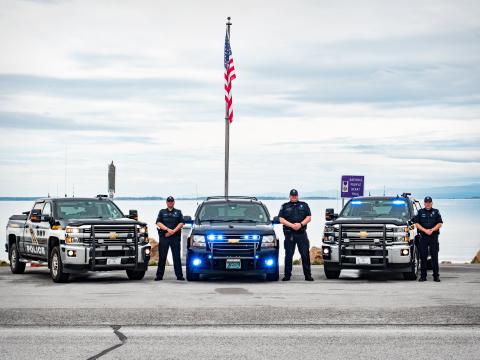 Three police cars with officers