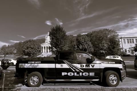 DMV police vehicle parked by the statehouse