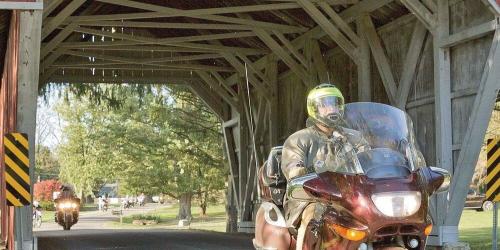 motorcycle crossing a covered bridge