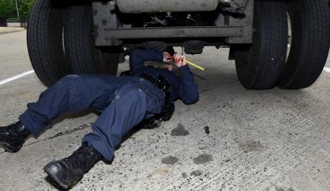 Inspector check under a truck