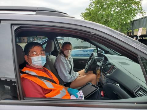 Driver examiner and a customer prepare to take the road test