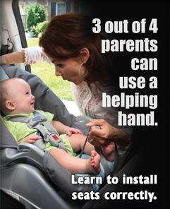 mom and child checking a car seat