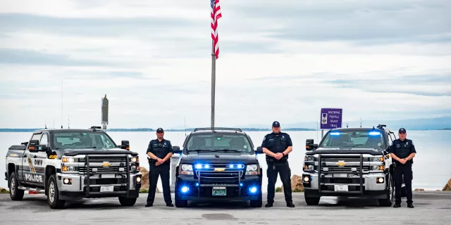 Three police cars with officers