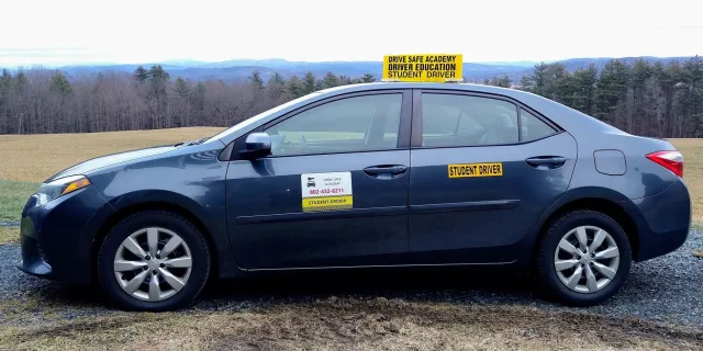 A car with driver education signs on it