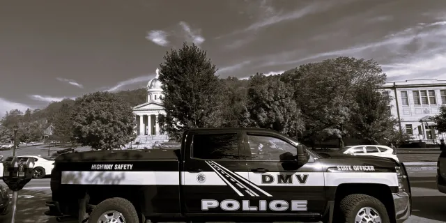 DMV police vehicle parked by the statehouse