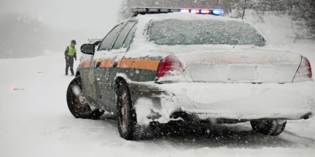 snow covered police car